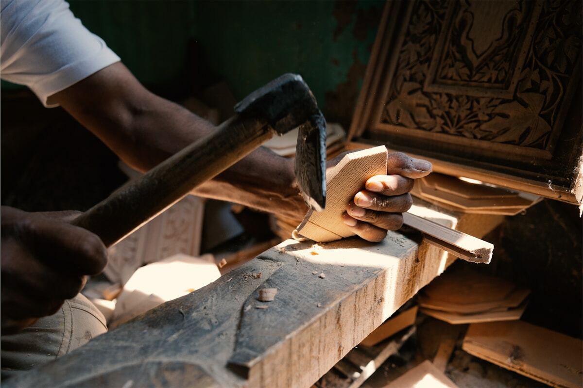 A man is working on a piece of wood