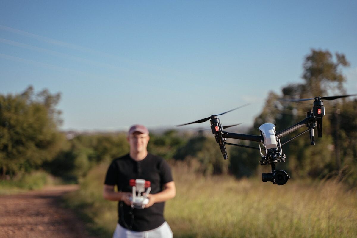 a man standing next to a small black and white plane